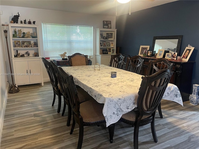 dining space with wood-type flooring