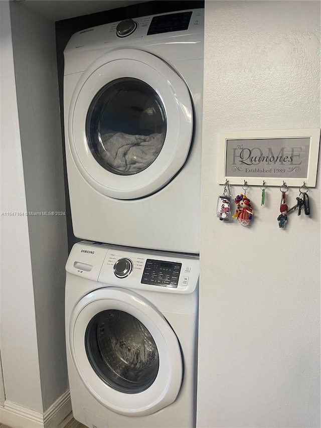 laundry room featuring stacked washer and clothes dryer