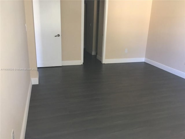 3253 Foxcroft Rd Unit G210, Miramar, FL 33025 - unfurnished room with dark wood-style flooring and baseboards