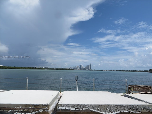 view of dock featuring a water view and a city view