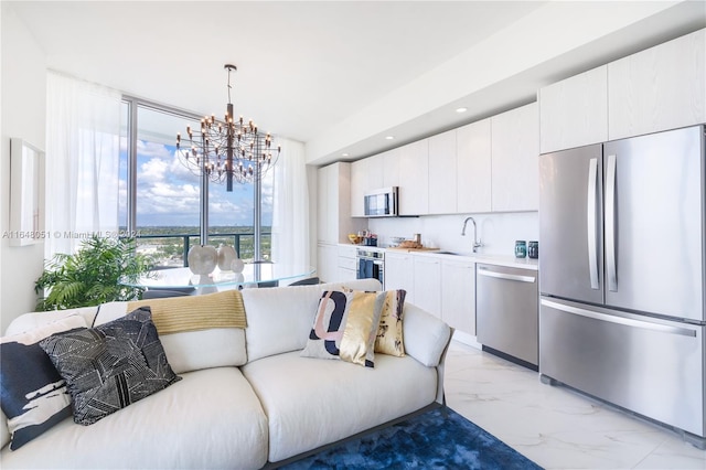 living room featuring light tile patterned floors, sink, and an inviting chandelier