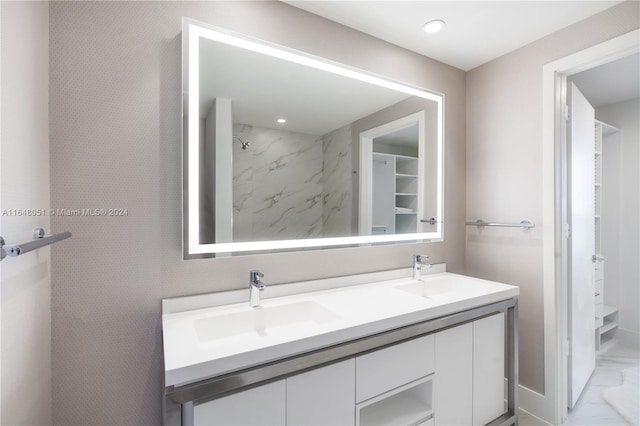 bathroom featuring a shower and vanity