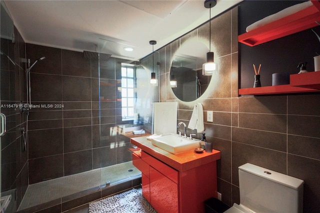 bathroom featuring tile walls, backsplash, a shower with door, and vanity