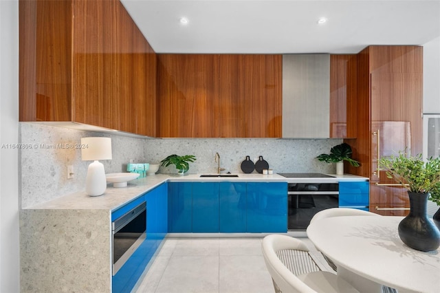 kitchen with backsplash, sink, black electric stovetop, and wall oven