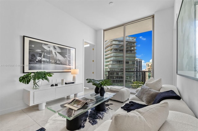 living area featuring a view of city, floor to ceiling windows, baseboards, and tile patterned floors