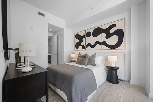 bedroom with tile patterned flooring and visible vents