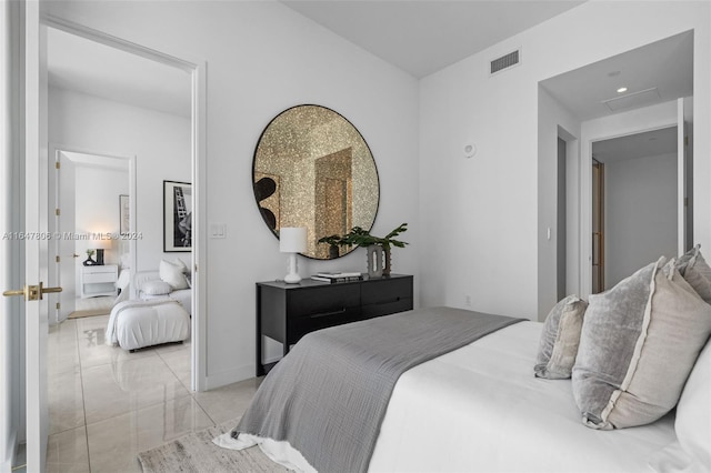 bedroom with baseboards and visible vents