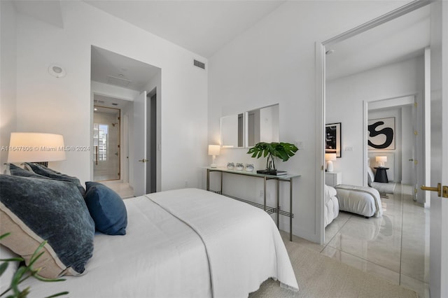 bedroom with marble finish floor and visible vents