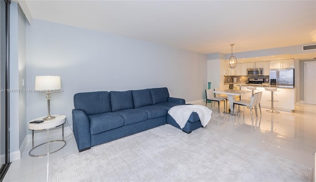 600 Three Islands Blvd Unit 1501, Hallandale Beach, FL 33009 - living room with light tile patterned flooring, baseboards, and a chandelier