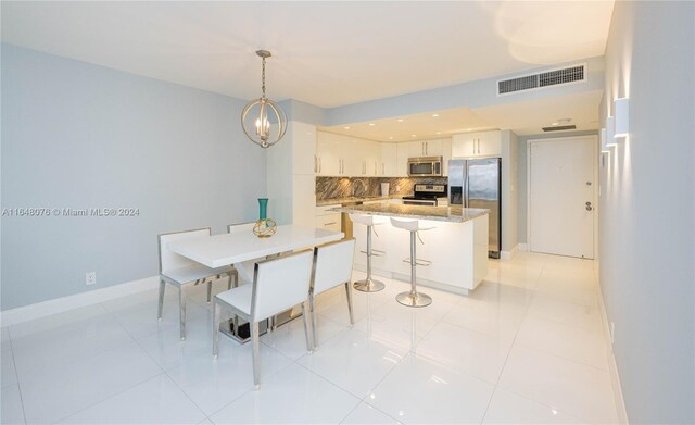 600 Three Islands Blvd Unit 1501, Hallandale Beach, FL 33009 - dining area with baseboards, light tile patterned flooring, and a chandelier