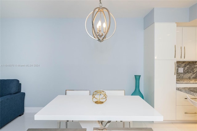 tiled dining room featuring a notable chandelier