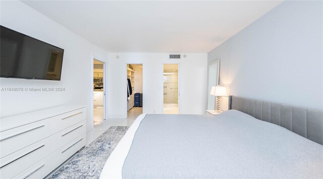 600 Three Islands Blvd Unit 1501, Hallandale Beach, FL 33009 - bedroom featuring a walk in closet, connected bathroom, and a closet