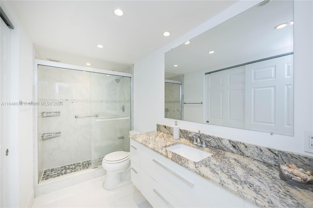 bathroom with vanity, toilet, tile patterned floors, and an enclosed shower