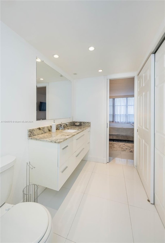 600 Three Islands Blvd Unit 1501, Hallandale Beach, FL 33009 - ensuite bathroom featuring toilet, vanity, tile patterned flooring, and recessed lighting