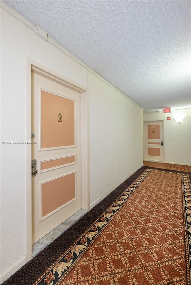 hallway with a textured ceiling