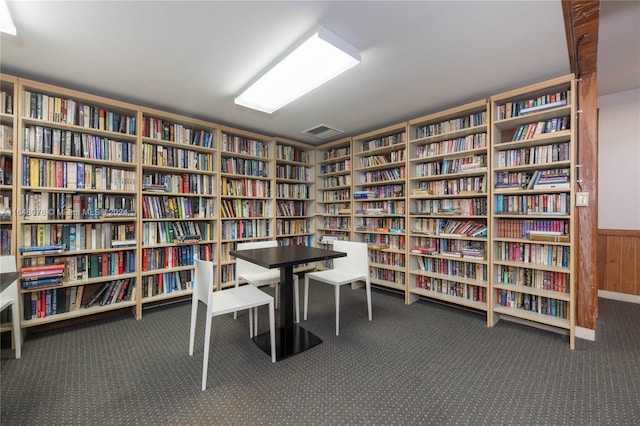 600 Three Islands Blvd Unit 1501, Hallandale Beach, FL 33009 - home office featuring wall of books, carpet, and wooden walls