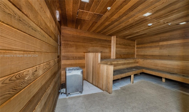 view of sauna / steam room with wood ceiling, tile patterned floors, and wooden walls