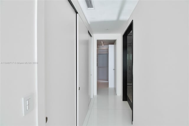 hall featuring light tile patterned flooring