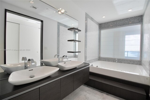 bathroom featuring vanity and a washtub