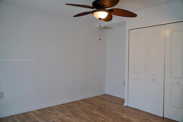 unfurnished bedroom with hardwood / wood-style flooring, a closet, and ceiling fan