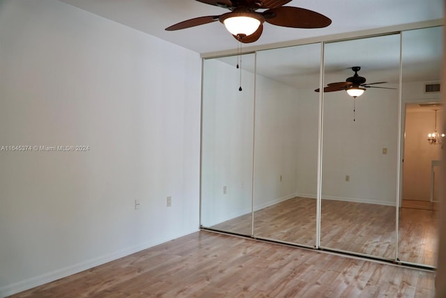 unfurnished bedroom featuring ceiling fan, a closet, and hardwood / wood-style floors