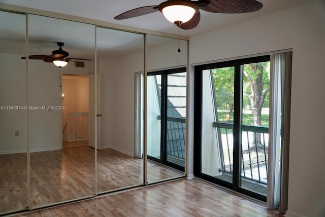 interior space with ceiling fan, light hardwood / wood-style flooring, and a closet