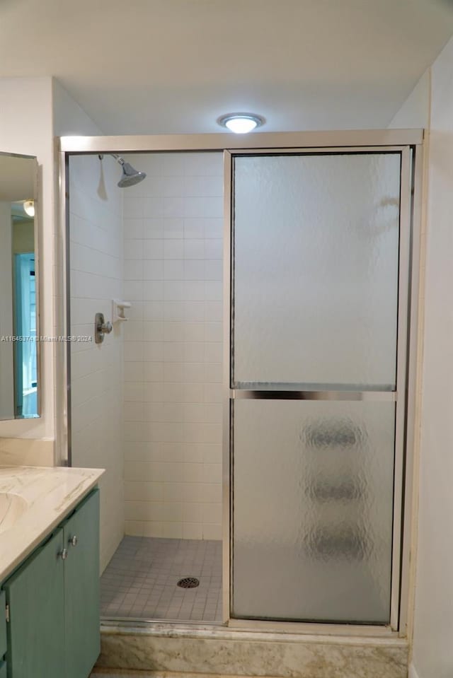 bathroom with vanity and a shower with shower door