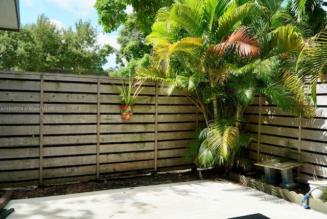 view of gate featuring a patio area