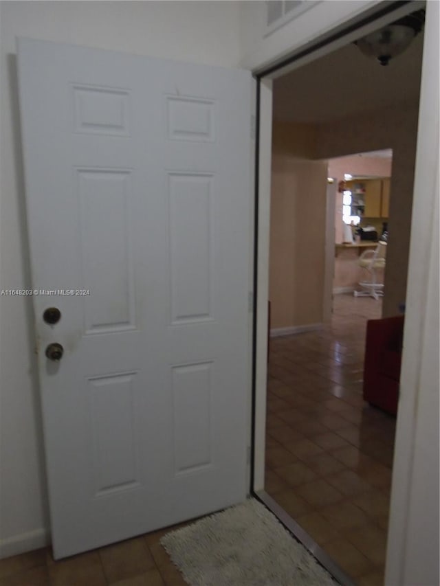 hallway featuring tile patterned floors