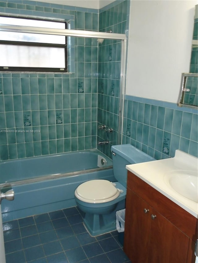 158 NW 18th Ct, Miami, FL 33125 - full bathroom featuring tile patterned floors, vanity, bathtub / shower combination, and tile walls