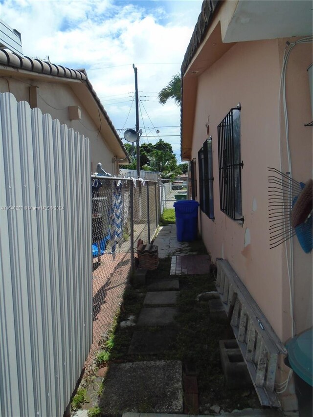 158 NW 18th Ct, Miami, FL 33125 - view of side of home featuring stucco siding and a tiled roof