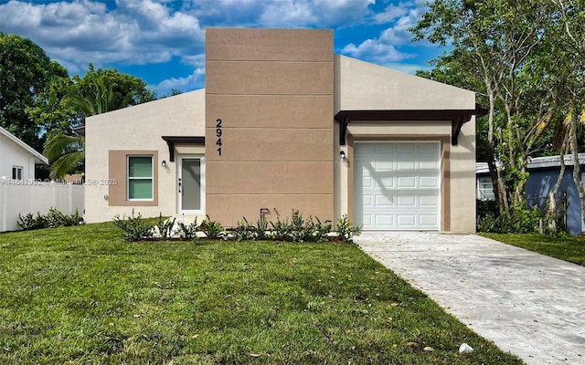 view of front of home with a garage and a front lawn