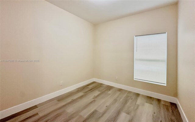 unfurnished room with light hardwood / wood-style flooring