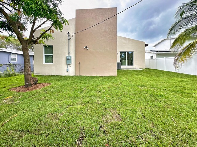 rear view of house with a yard