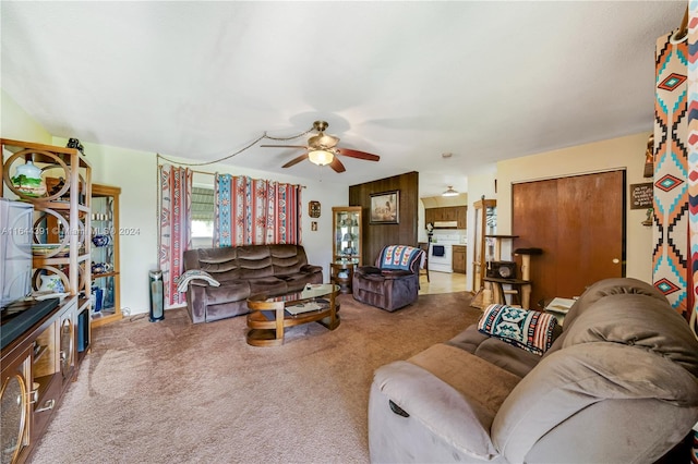 carpeted living room with ceiling fan