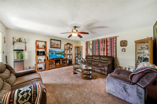 carpeted living room with a textured ceiling and ceiling fan