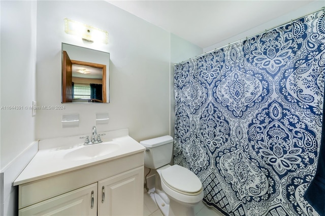 bathroom featuring tile patterned flooring, vanity, toilet, and walk in shower