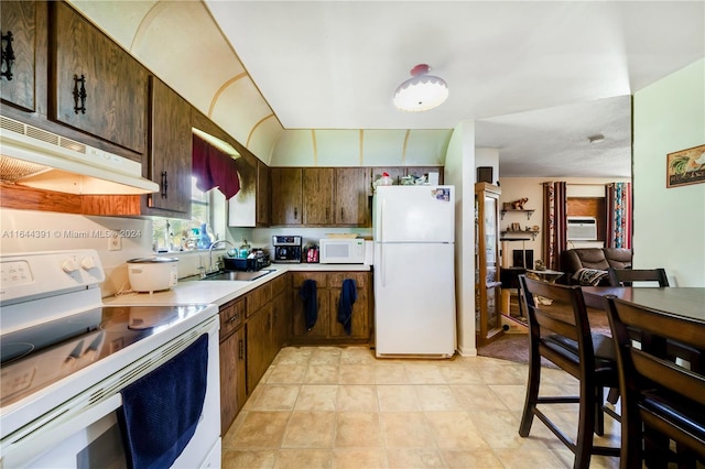 kitchen featuring white appliances, ventilation hood, sink, light tile patterned floors, and a wall unit AC