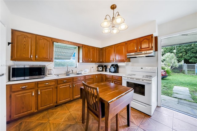 kitchen featuring light parquet floors, sink, decorative light fixtures, white electric stove, and a notable chandelier