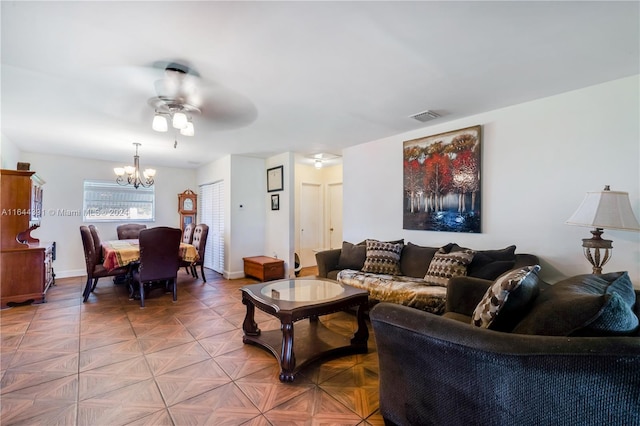 living room with ceiling fan with notable chandelier and parquet flooring