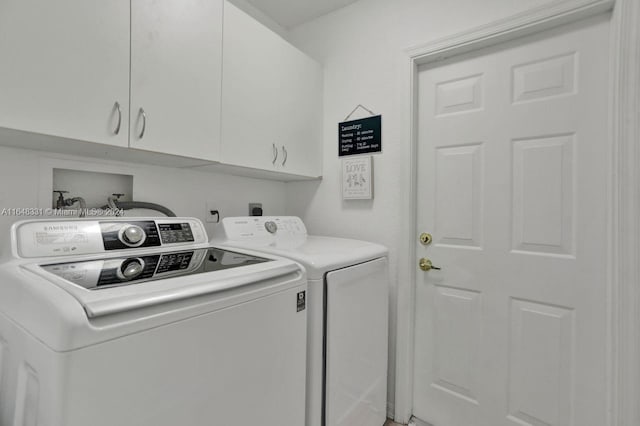 clothes washing area with cabinets and separate washer and dryer