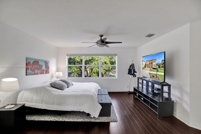 bedroom featuring dark wood-type flooring, multiple windows, and ceiling fan