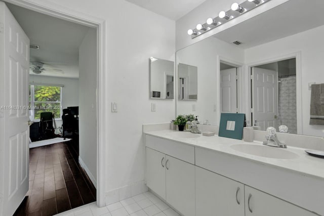 bathroom with hardwood / wood-style floors, ceiling fan, and vanity