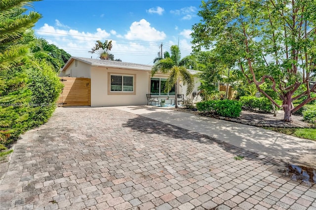 view of front of property with stucco siding and decorative driveway