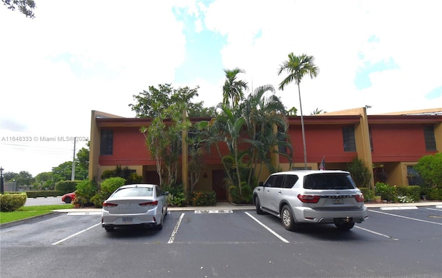 view of property featuring uncovered parking