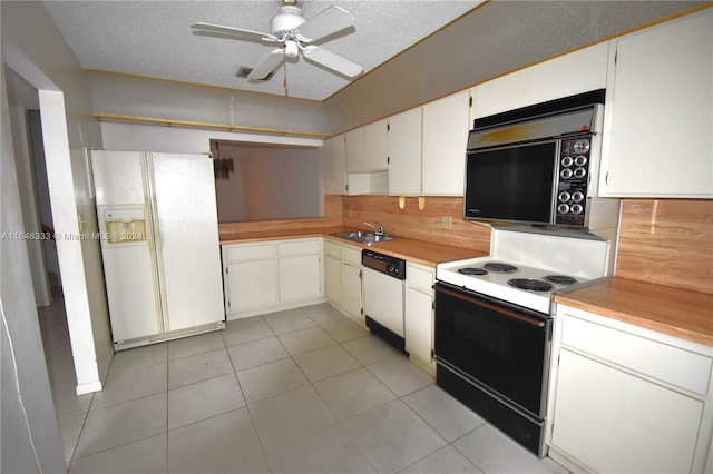 kitchen with light countertops, white appliances, a sink, and decorative backsplash