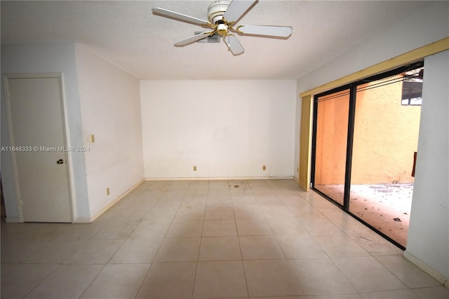 unfurnished bedroom featuring a textured ceiling, baseboards, and a ceiling fan