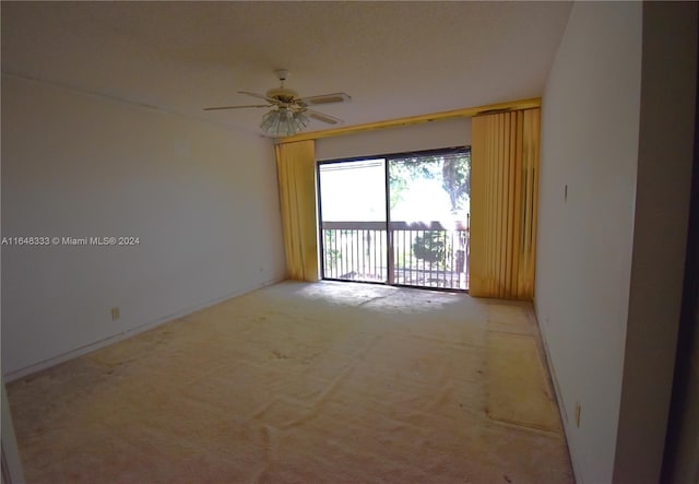 unfurnished room with carpet and a ceiling fan