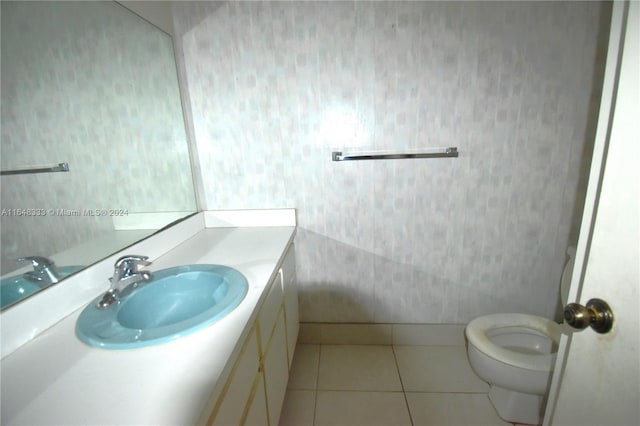 bathroom featuring toilet, tile patterned flooring, and vanity