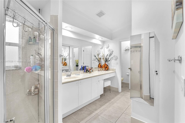 bathroom featuring vanity, a shower with shower door, toilet, ornamental molding, and tile patterned floors